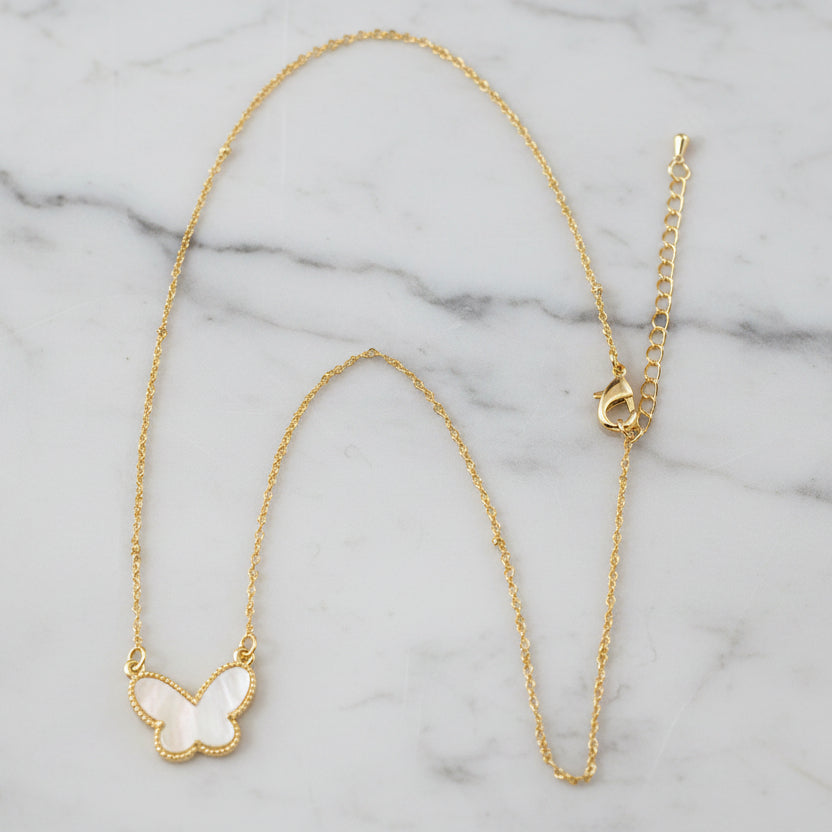 Lorena dainty chain necklace with a white mother-of-pearl butterfly pendant on a 16-inch chain.