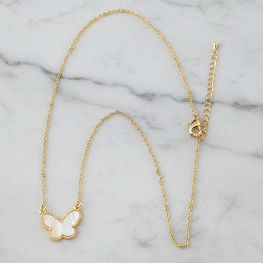 Lorena dainty chain necklace with a white mother-of-pearl butterfly pendant on a 16-inch chain.