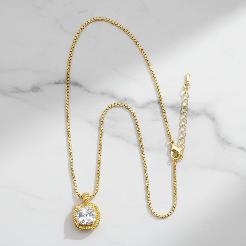 Lorena dainty gold necklace with CZ pendant, featuring a delicate chain and sparkling cubic zirconia stone.