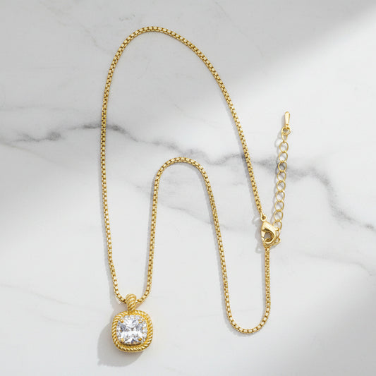 Lorena dainty gold necklace with CZ pendant, featuring a delicate chain and sparkling cubic zirconia stone.