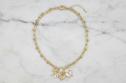 Lorena gold chain necklace featuring playful bug charms, stylish jewelry accessory for everyday wear and unique fashion statements.