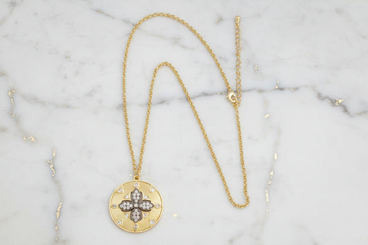 Lorena gold and hematite flower pendant necklace, 16-inch length, featuring a detailed floral design with shiny gold and hematite accents.