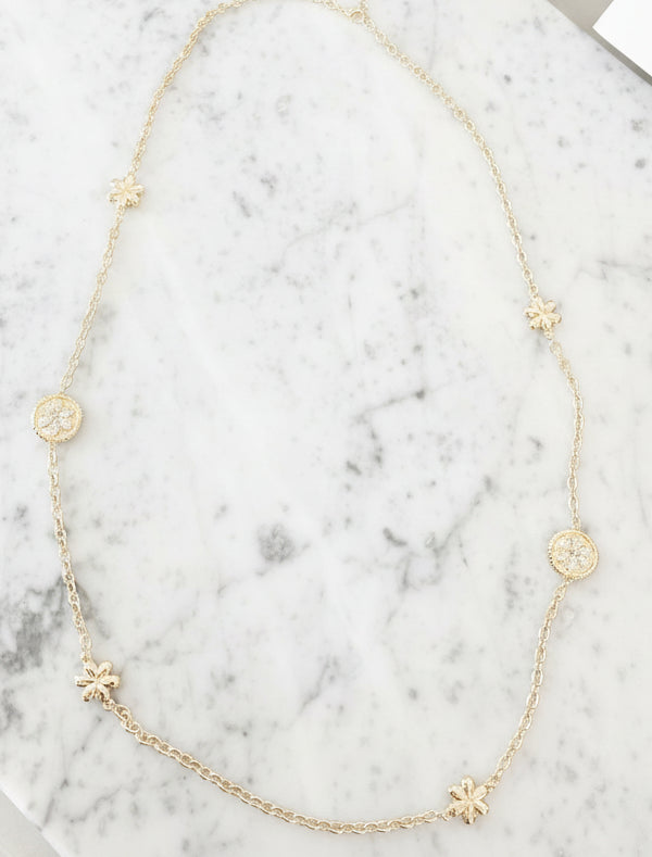 Lorena gold necklace with pave flower design, 36-inch length, showcasing intricate floral details and elegant craftsmanship.