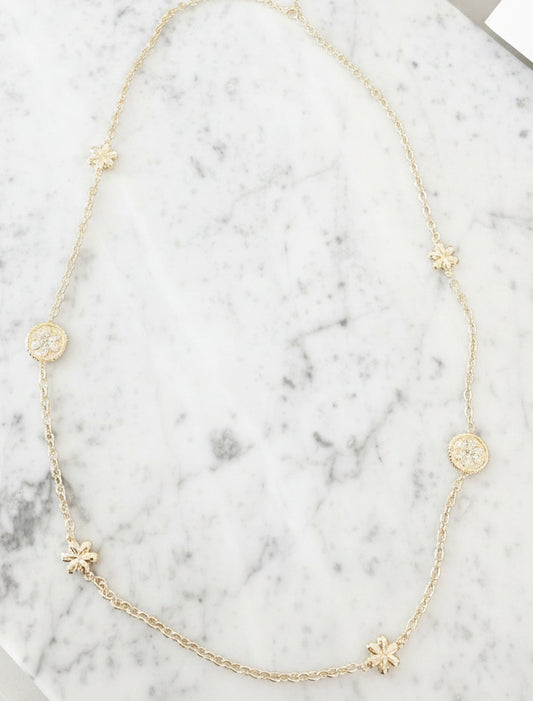 Lorena gold necklace with pave flower design, 36-inch length, showcasing intricate floral details and elegant craftsmanship.