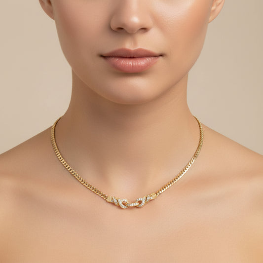 Lorena gold snake necklace with CZ swirl design, showcasing a sleek and elegant jewelry piece on a neutral background.