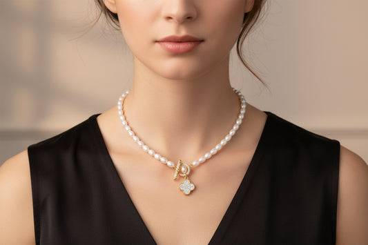 Lorena pearl necklace with pave toggle clasp and charm accents, elegant jewelry piece featuring lustrous pearls and intricate details.