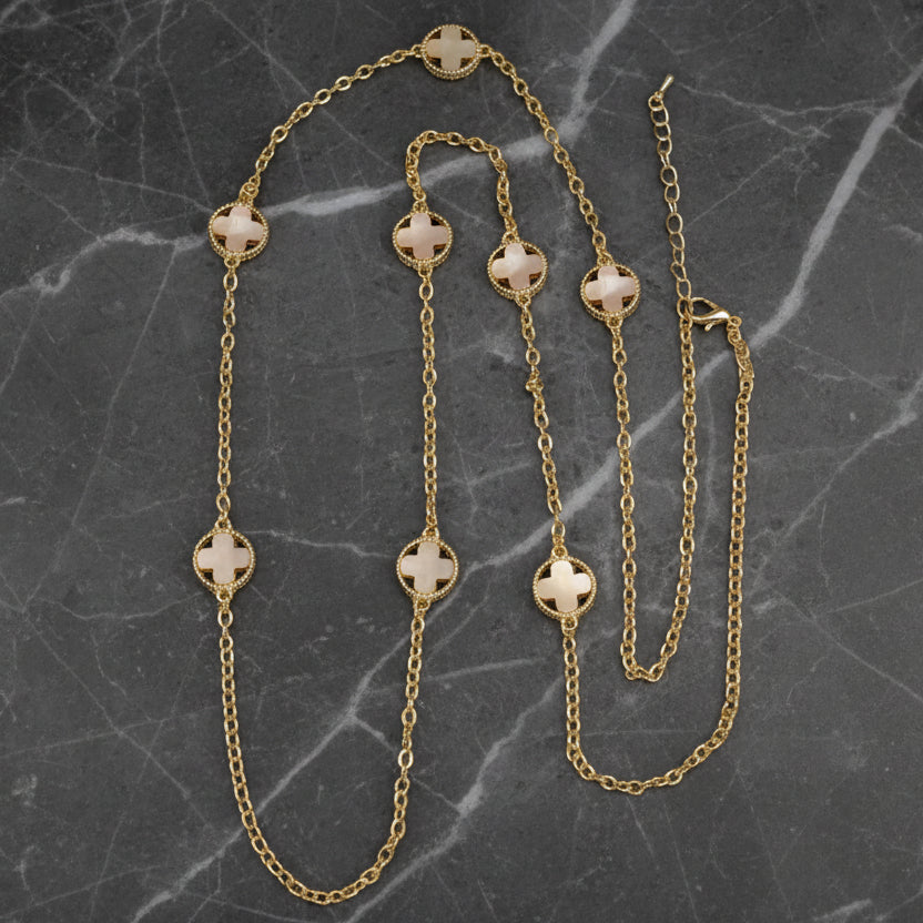 Lorena 36-inch gold chain necklace with white mother-of-pearl clover pendants, showcasing elegant jewelry design.