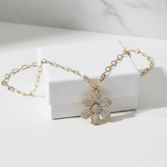 Lorena gold chain necklace featuring a delicate flower pendant, showcasing elegant jewelry design and craftsmanship.