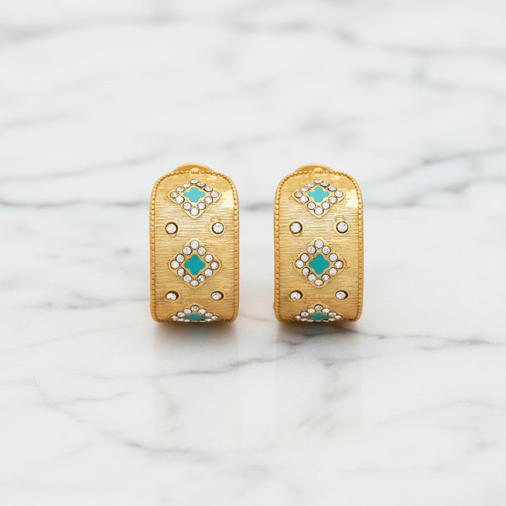 Marcony brushed gold hoop earrings with clover designs, showcasing elegant jewelry with a floral motif.