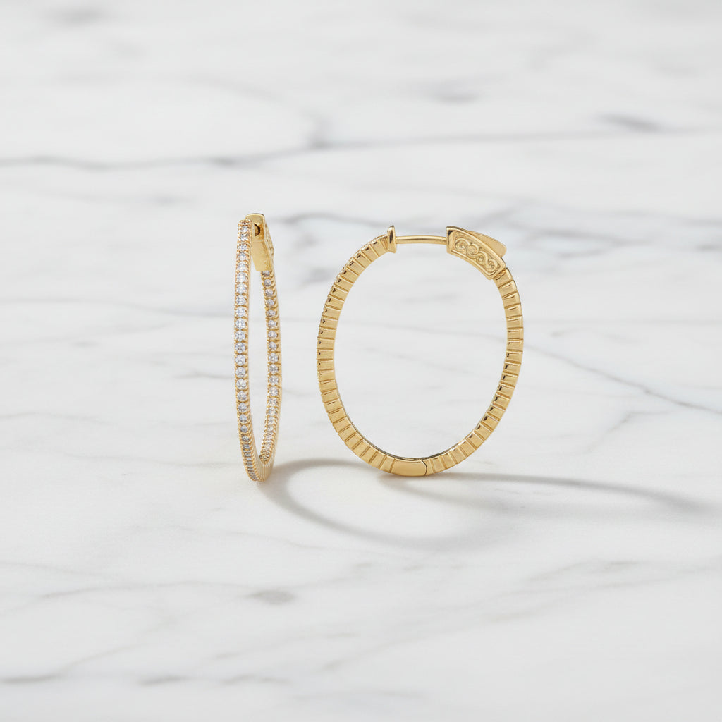 Marcony 1.5-inch oval cubic zirconia hoop earring with shiny silver finish, showcasing elegant jewelry design.