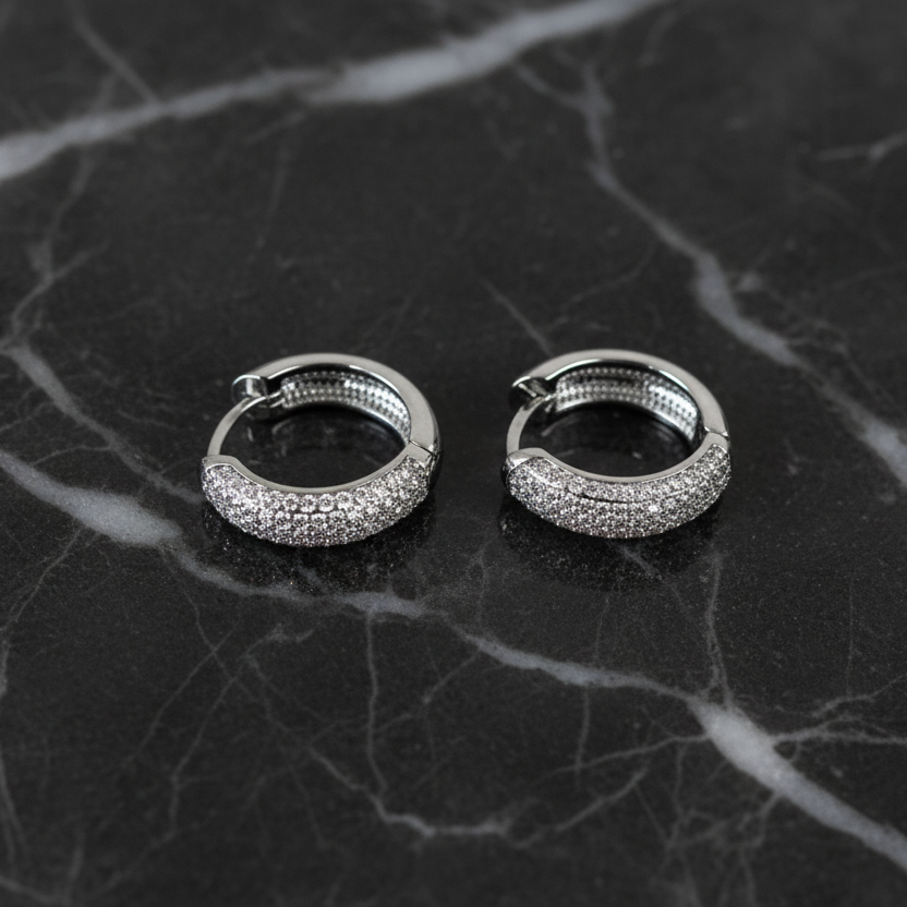 RM 0.8-inch CZ huggie earring with sparkling cubic zirconia stones and a sleek silver-tone finish.