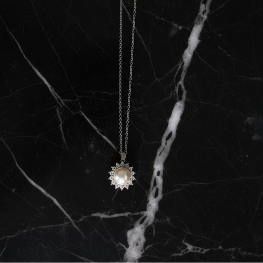 Gold Pearl CZ Flower Necklace by RM featuring a delicate floral design with shimmering pearls and cubic zirconia accents.